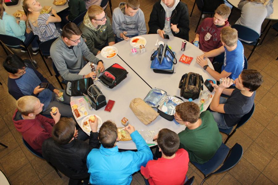 Students socialize at lunch while eating over priced snacks and beverages