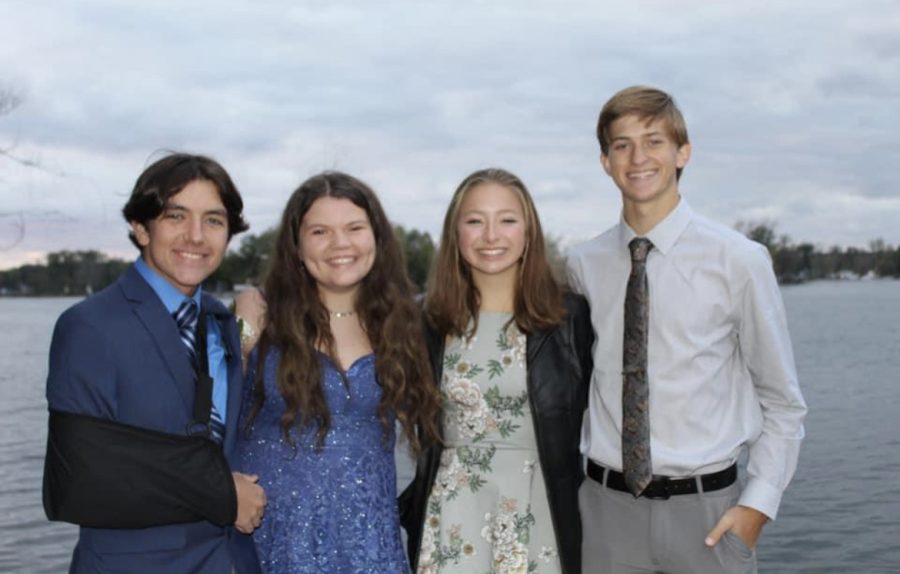 Camden Frederick, Grace Carlyle, Isabelle Delaet, and Dane Jorgenson taking pictures for the dance.